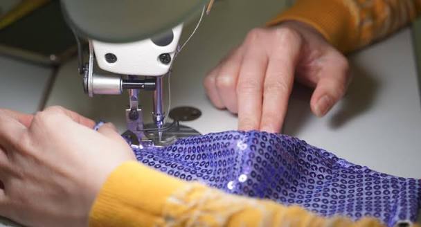 Tailor stitching a garment as part of Worth Care Drycleaner's stitching service in Gurgaon